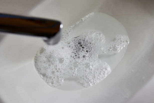 They wash their hands in the sink, the sewer pipe of which is clogged.