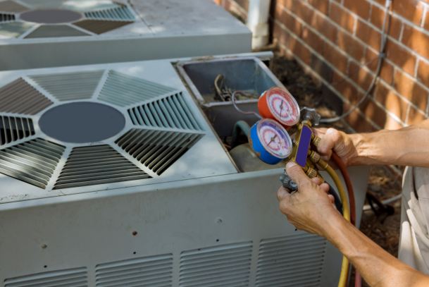 Atlas Trillo technician testing an AC system with a tool for air conditioning services outside a San Jose, CA, home.